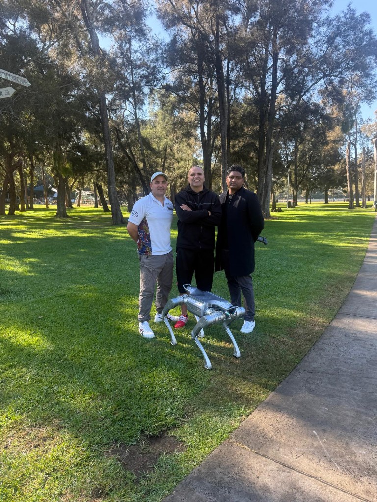 Anthony Mundine, Gosh Daher and the MGM team with a quadruped robot